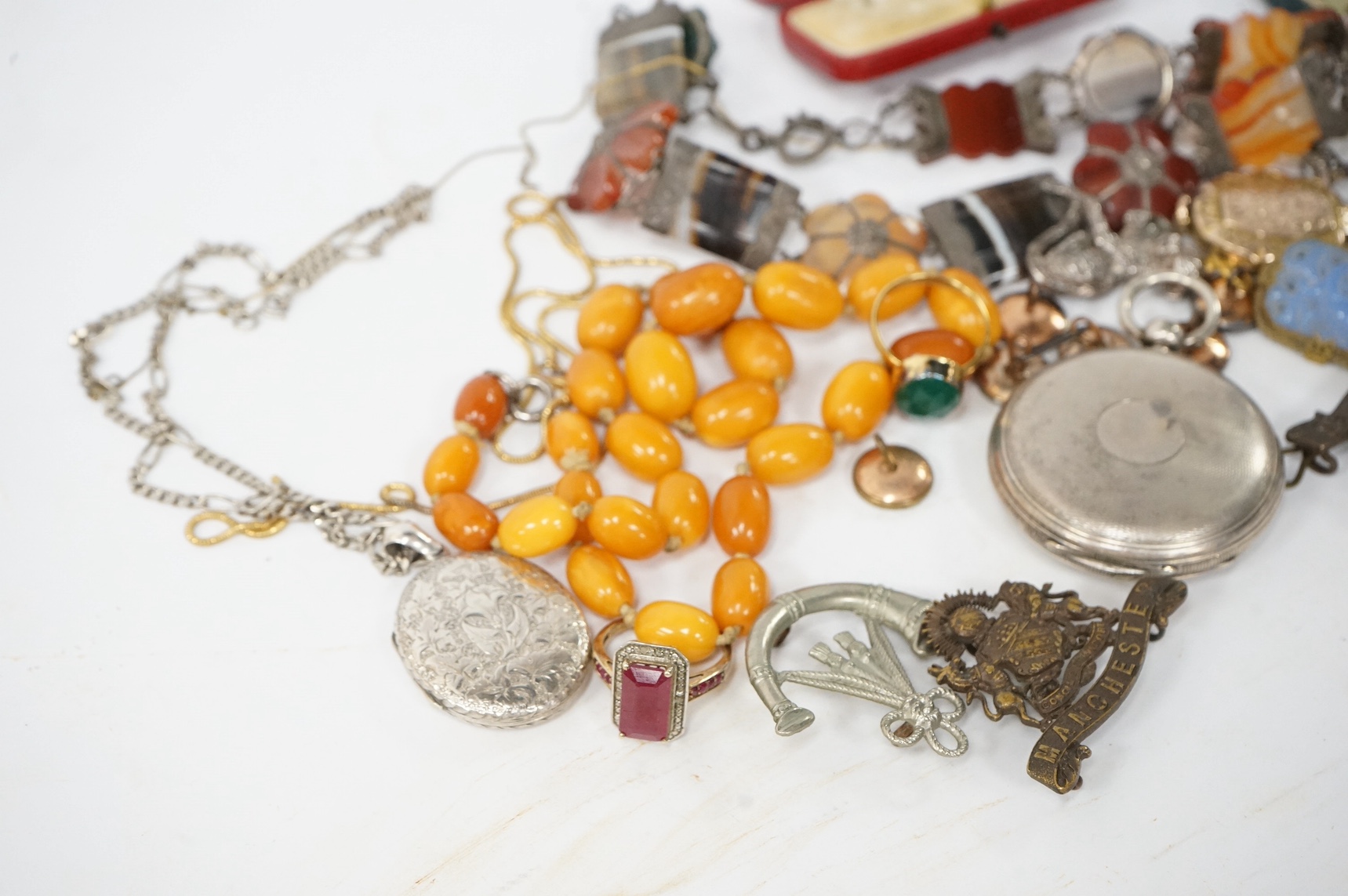 Assorted jewellery including an amber bead necklace, 46cm, gross 29 grams, a white metal and Scottish hardstone set necklace, cufflinks, dress studs, ring, a silver hunter pocket watch, engraved yellow metal oval locket,